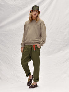 The Martin Elastic-waist Pleated Trouser in Olive is 100% cotton.