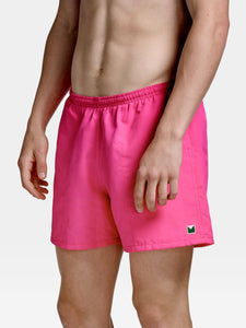 The Jeffery Hybrid Trunks in Neon Pink are cut in a soft moisture wicking cotton/nylon blend with a mesh lining.